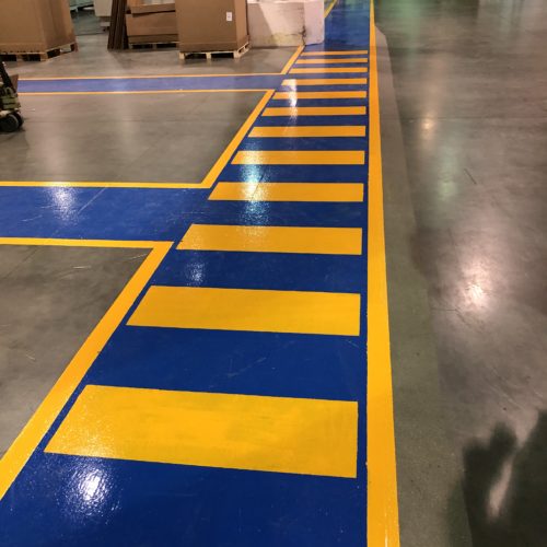 blue and yellow safety precaution lines in packaging factoy
