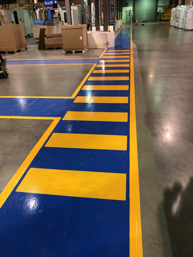 blue and yellow safety precaution lines in packaging factoy