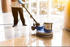 Cleaner polishing dirty floor as part of Dublin Floor Repair service