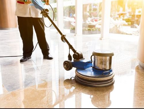 Cleaner polishing dirty floor as part of Dublin Floor Repair service